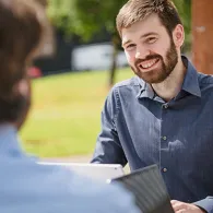 People sitting round a table outside
