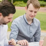 People grouped round a laptop