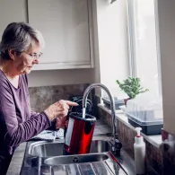 Woman filling kettle